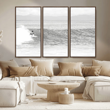 Monochrome photo of a surfer riding a wave with distant mountains, ideal for coastal motion or black and white surf-themed wall decor.