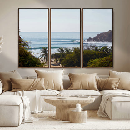 View of calm ocean waves with palm trees and a tropical coastline, ideal for coastal boho or beach-themed wall decor.
