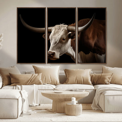 "Close-up of a brown and white longhorn cow with prominent curved horns against a black background."