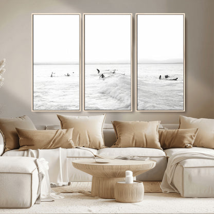Monochrome photo of surfers riding and waiting on ocean waves, ideal for surf-themed or coastal energy wall decor.