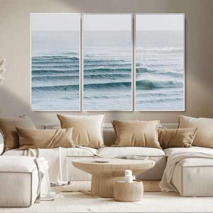 High-angle view of surfers lining up across layered ocean waves, ideal for minimal coastal or surf-inspired room decor.