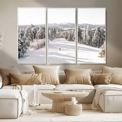 Bright ski trail lined with snow-covered pines and a skier in orange, perfect for alpine adventure or winter sports-inspired decor.