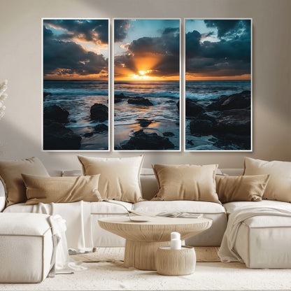 An awe-inspiring sunset over the ocean with rays of light piercing through dramatic clouds, creating a beautiful seascape with rocks in the foreground.