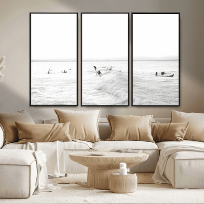 Monochrome photo of surfers riding and waiting on ocean waves, ideal for surf-themed or coastal energy wall decor.