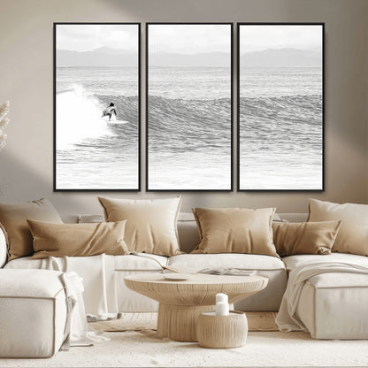 Monochrome photo of a surfer riding a wave with distant mountains, ideal for coastal motion or black and white surf-themed wall decor.