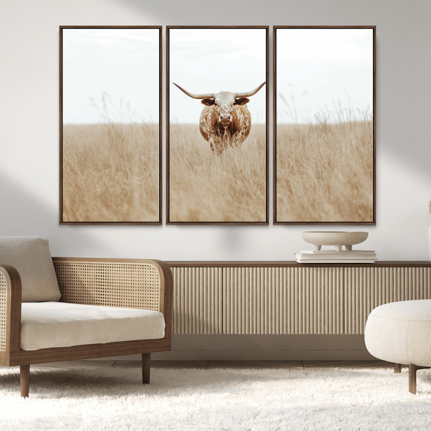 Texas Longhorn bull standing alone in dry grass with neutral tones, ideal for rustic western or cowboy-themed wall decor.