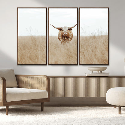 Texas Longhorn bull standing alone in dry grass with neutral tones, ideal for rustic western or cowboy-themed wall decor.