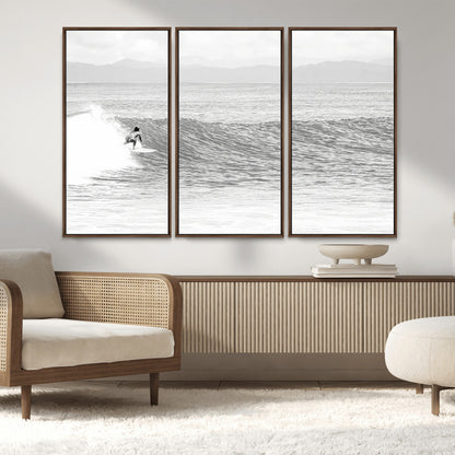 Monochrome photo of a surfer riding a wave with distant mountains, ideal for coastal motion or black and white surf-themed wall decor.