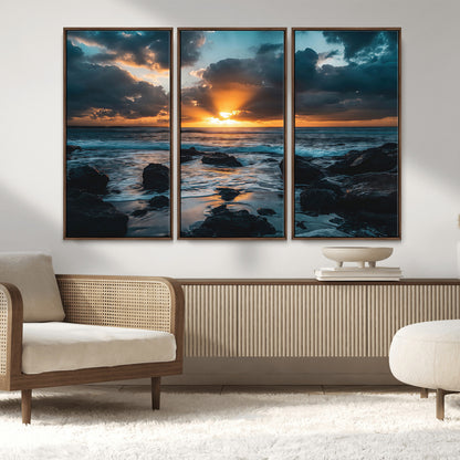 An awe-inspiring sunset over the ocean with rays of light piercing through dramatic clouds, creating a beautiful seascape with rocks in the foreground.