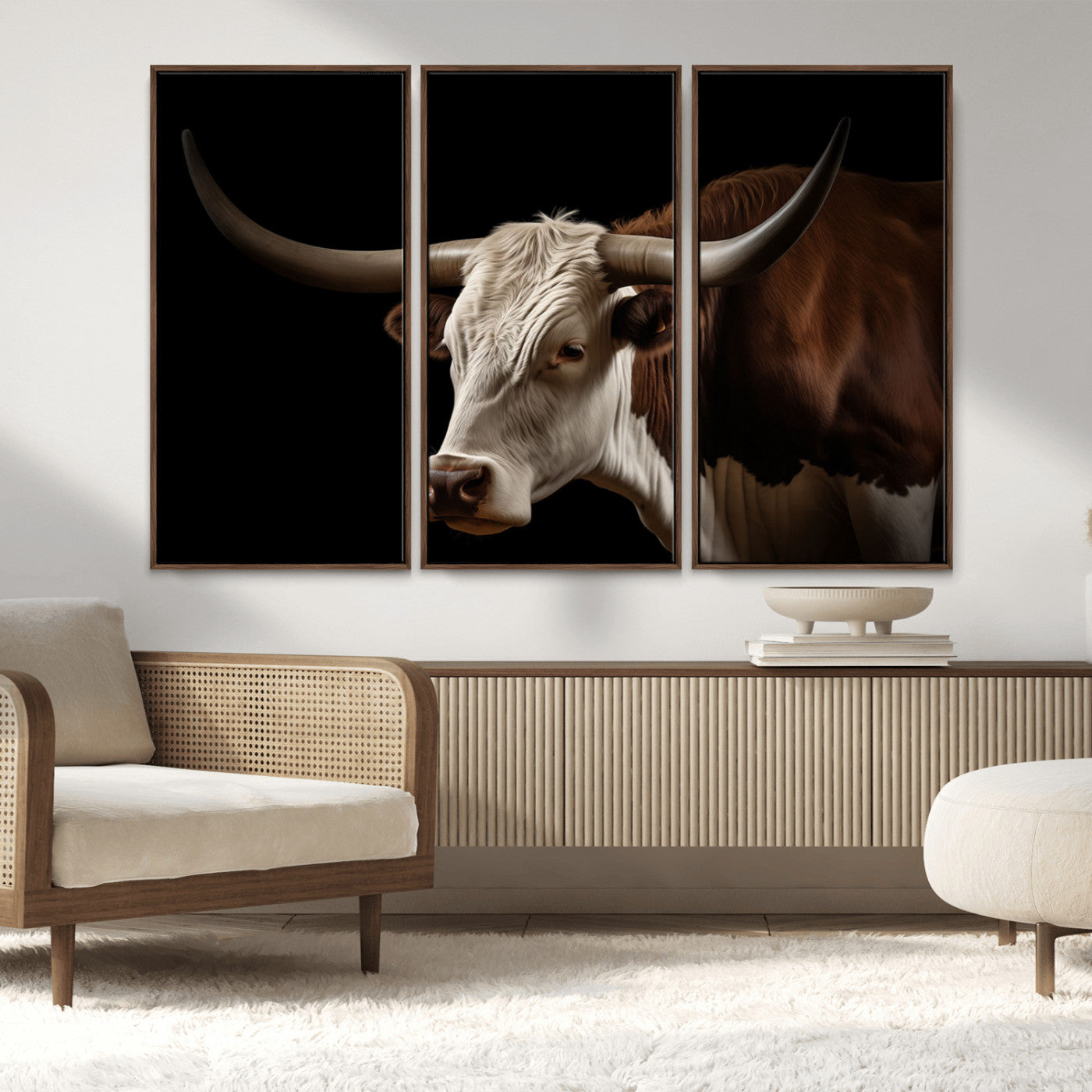 "Close-up of a brown and white longhorn cow with prominent curved horns against a black background."