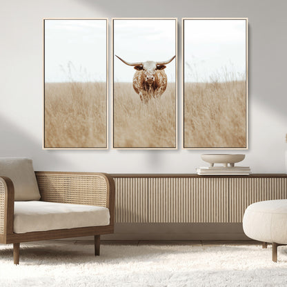 Texas Longhorn bull standing alone in dry grass with neutral tones, ideal for rustic western or cowboy-themed wall decor.