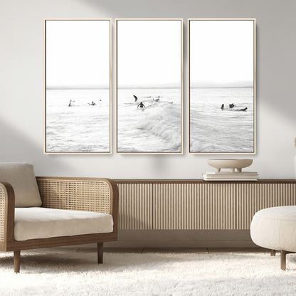Monochrome photo of surfers riding and waiting on ocean waves, ideal for surf-themed or coastal energy wall decor.