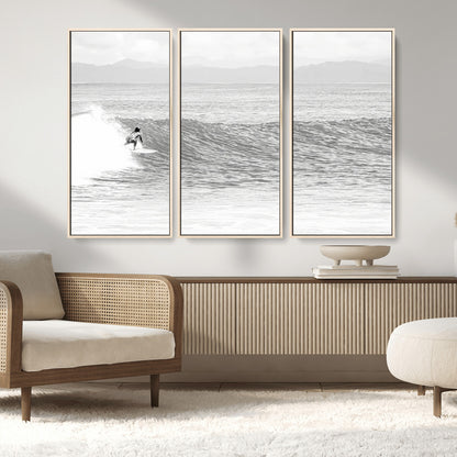 Monochrome photo of a surfer riding a wave with distant mountains, ideal for coastal motion or black and white surf-themed wall decor.