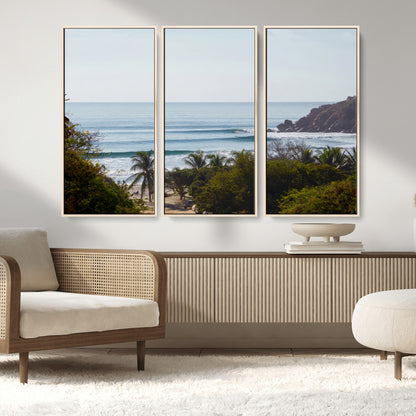 View of calm ocean waves with palm trees and a tropical coastline, ideal for coastal boho or beach-themed wall decor.