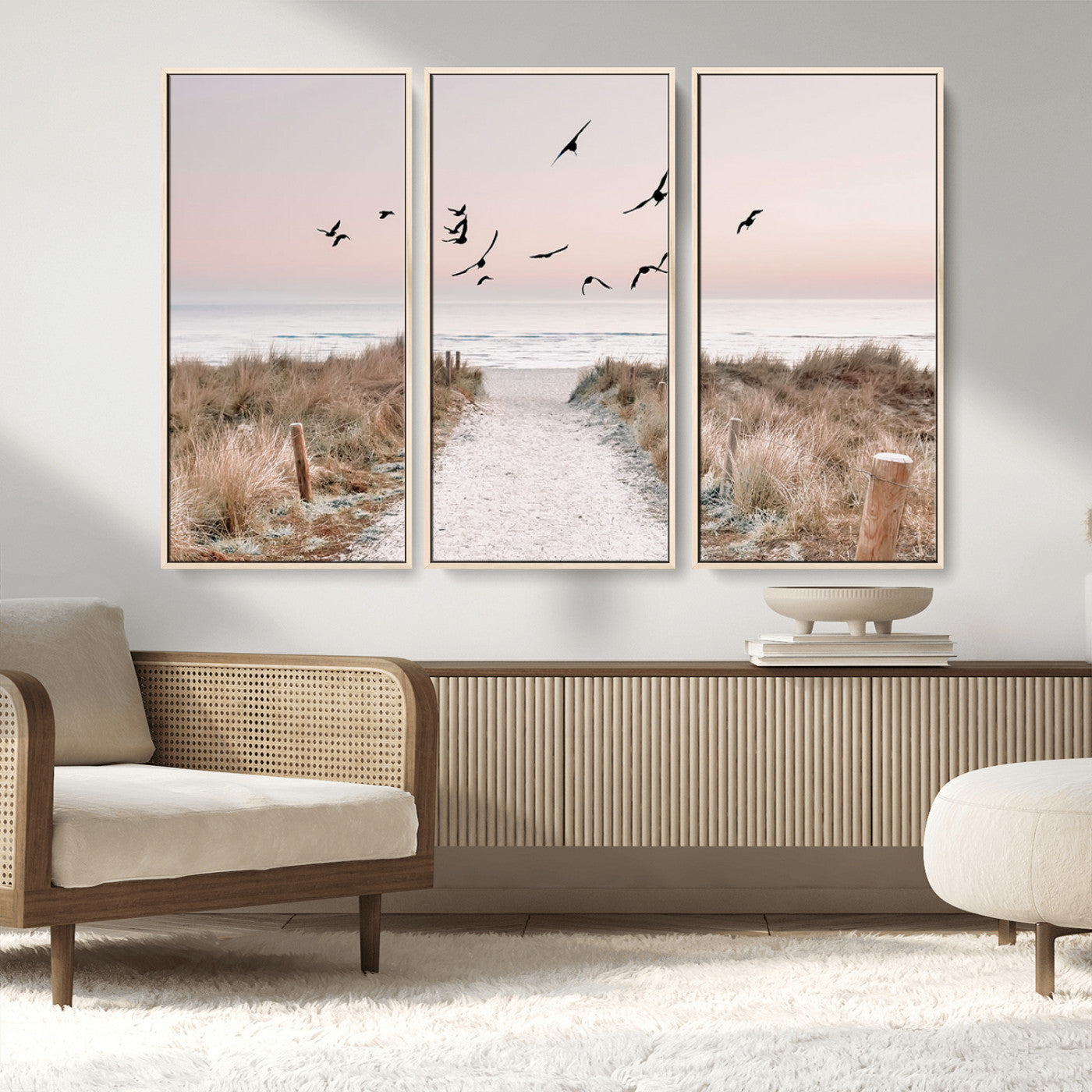 A peaceful coastal pathway leading to the ocean, with birds flying across a soft pastel sky, creating a calm and scenic beach atmosphere.