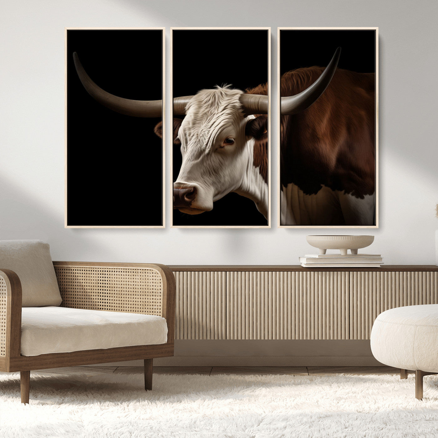 "Close-up of a brown and white longhorn cow with prominent curved horns against a black background."