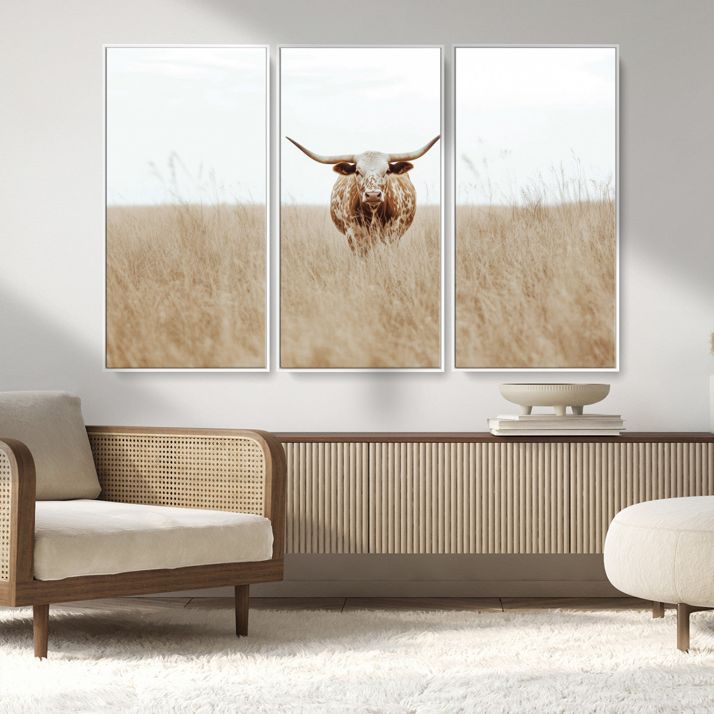 Texas Longhorn bull standing alone in dry grass with neutral tones, ideal for rustic western or cowboy-themed wall decor.