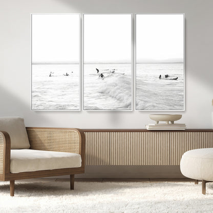 Monochrome photo of surfers riding and waiting on ocean waves, ideal for surf-themed or coastal energy wall decor.
