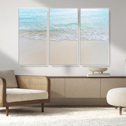Soft shoreline with gentle aqua waves on smooth sand, ideal for minimalist coastal or pastel ocean-inspired home wall decor.