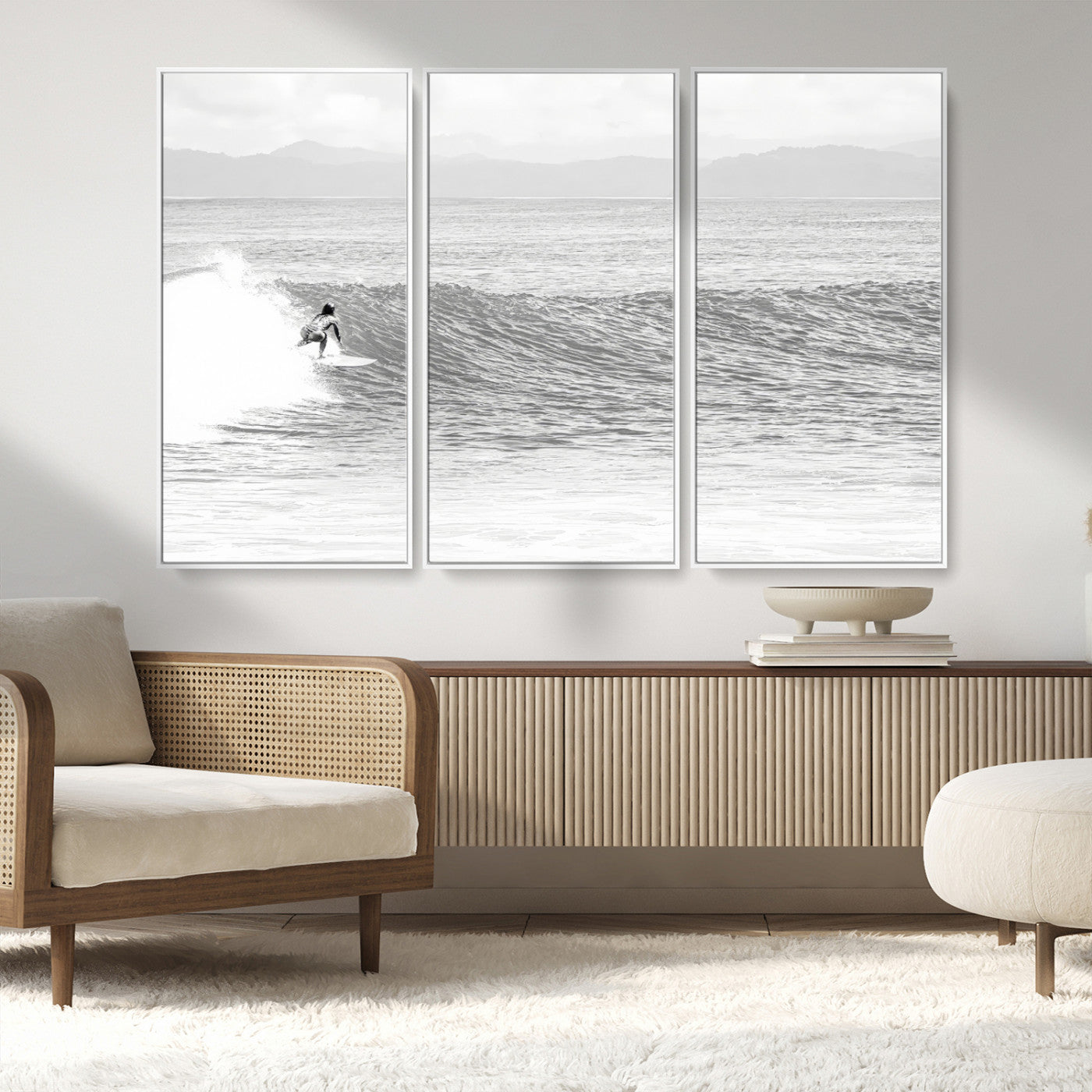 Monochrome photo of a surfer riding a wave with distant mountains, ideal for coastal motion or black and white surf-themed wall decor.
