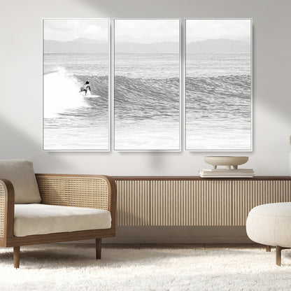 Monochrome photo of a surfer riding a wave with distant mountains, ideal for coastal motion or black and white surf-themed wall decor.