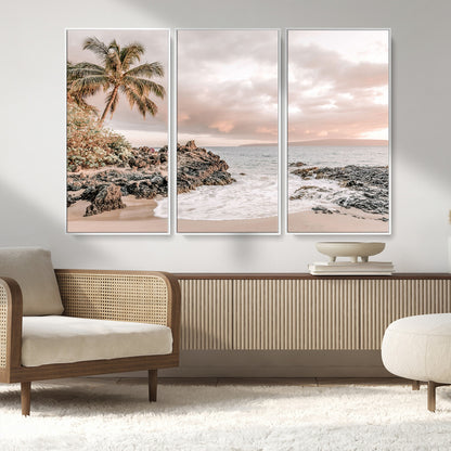 A peaceful beach scene with a palm tree and rocks, soft waves washing onto the shore under a soft pastel sky at sunset.