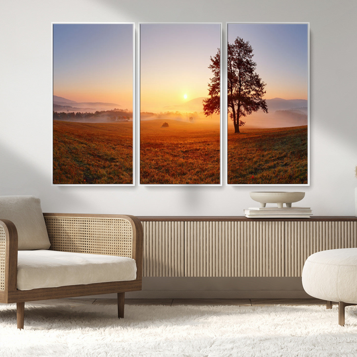 A tranquil landscape at sunrise with a mist-covered field and a lone tree, creating a peaceful and natural atmosphere.