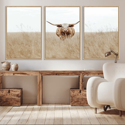Texas Longhorn bull standing alone in dry grass with neutral tones, ideal for rustic western or cowboy-themed wall decor.