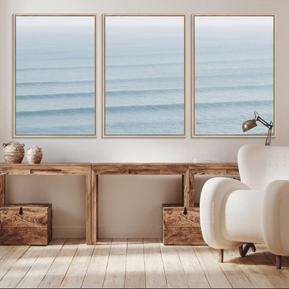 Framed canvas of repeating ocean waves with a distant solo surfer, ideal for minimalist ocean or calm coastal wall decor.