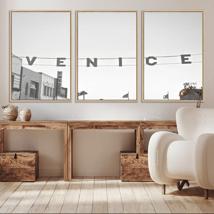 Black and white photo of Venice Beach sign and palm-lined street, perfect for urban coastal or minimalist LA-inspired wall decoration.