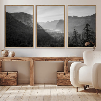 Black and white landscape of Yosemite with sun rays peeking over El Capitan, ideal for moody nature or modern rustic decor.