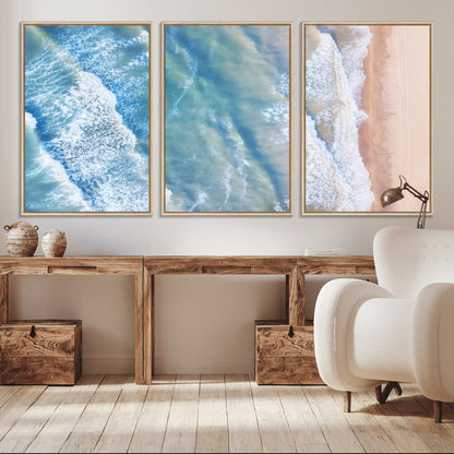 Aerial photo of soft blue waves meeting sandy shore, perfect for modern coastal or beach-themed decor with a light and tranquil aesthetic.