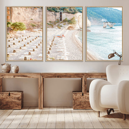 Wall art of a calm Mediterranean beach with rows of sun loungers and umbrellas in soft pastel tones, perfect for light coastal or vacation-themed decor.