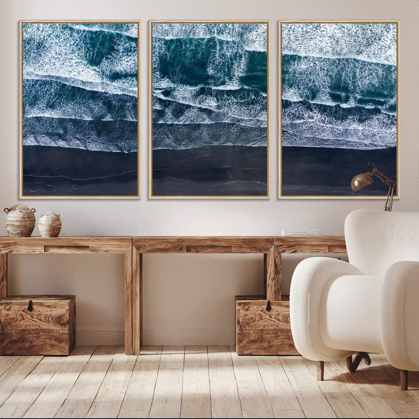 Canvas of aerial ocean waves crashing onto a black sand beach in moody tones, ideal for modern coastal or minimalist home decor.