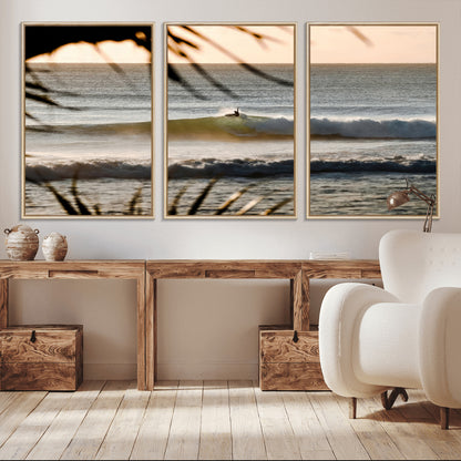 Photo of a surfer riding a golden hour wave at sunset, with tropical tones and dreamy light, perfect for tropical boho or coastal home decor.
