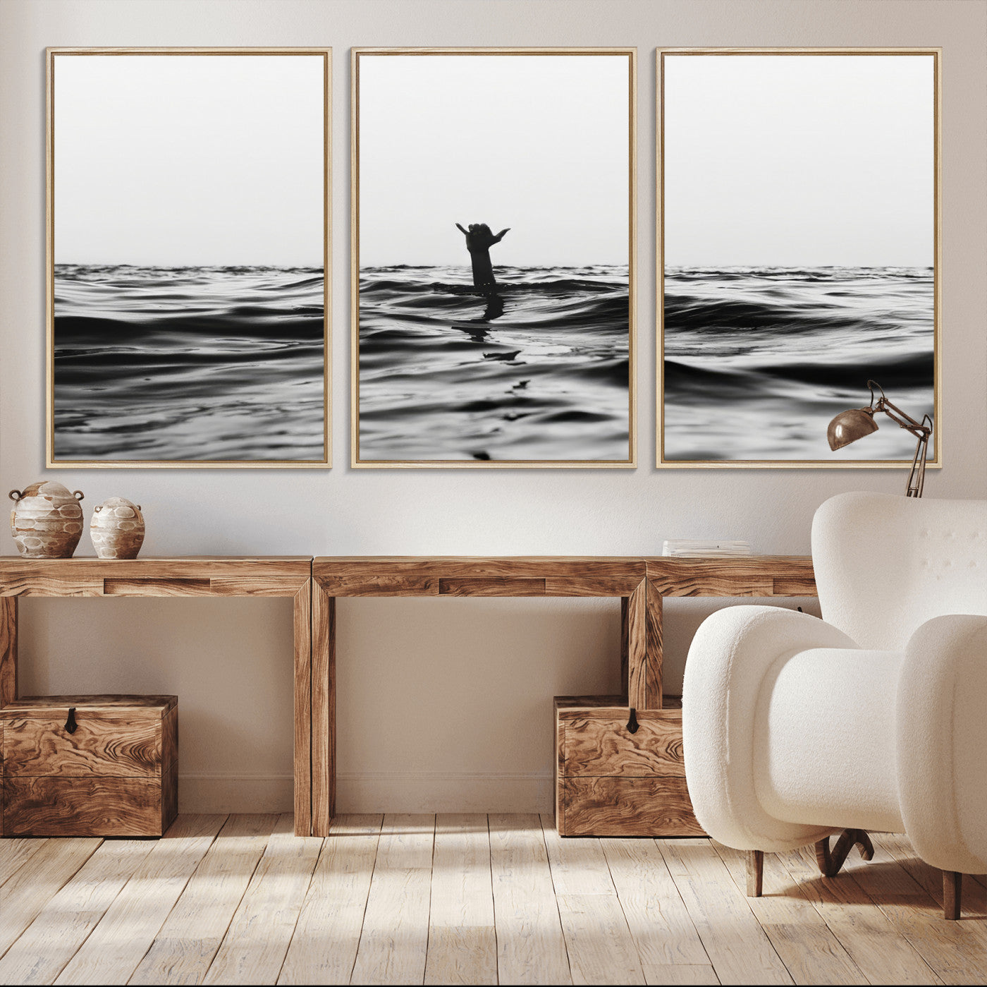 Black and white ocean with a hand making a surfer sign among dark waves, creating a dramatic and minimalist seascape with bold contrast.