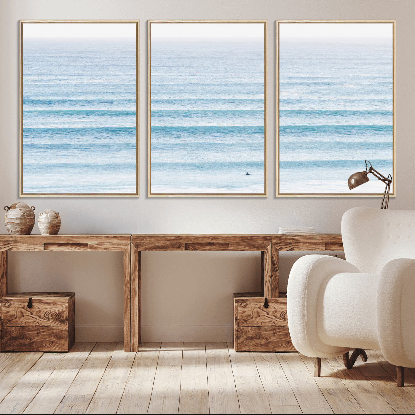 Minimalist ocean view with soft blue waves and a lone surfer, creating a serene and airy coastal aesthetic, perfect for tranquil home decor.