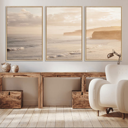 Golden hour seascape with misty cliffs and gentle waves rolling towards the shore, capturing a tranquil and warm coastal atmosphere.