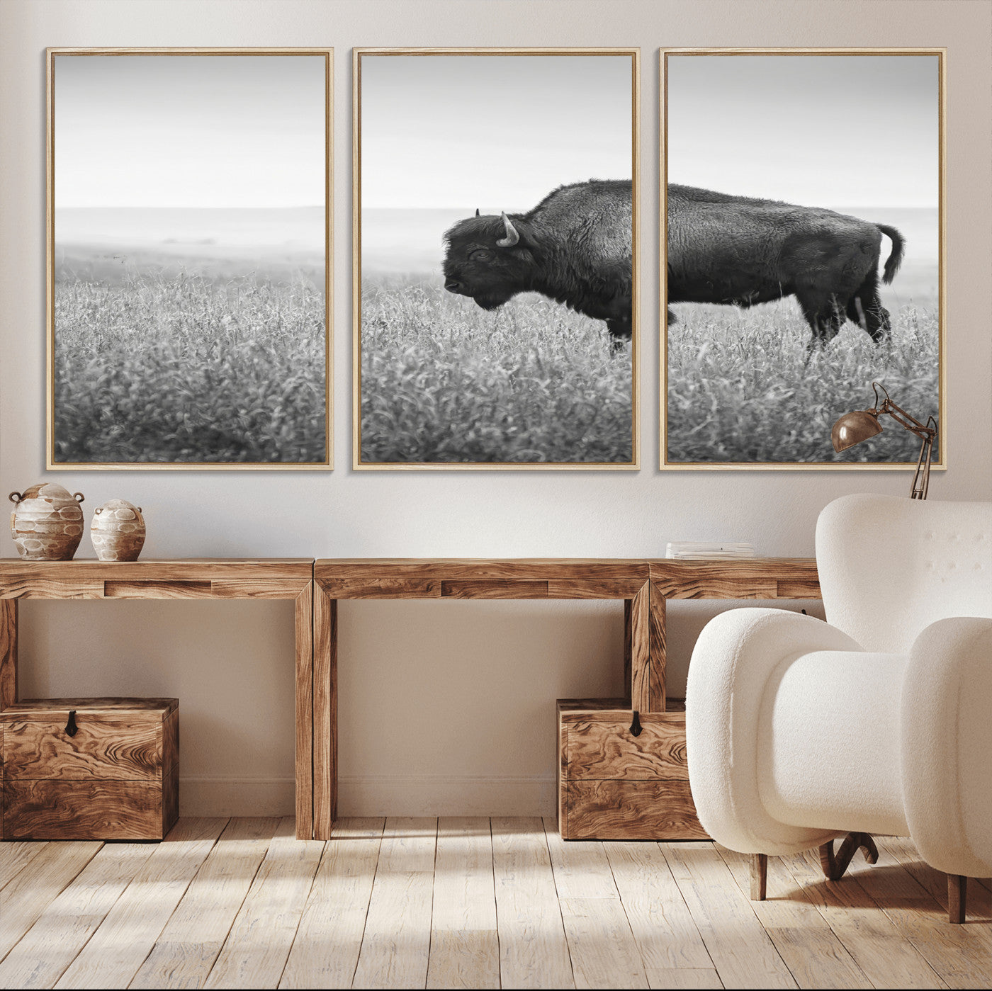 A black and white photograph of a majestic bison standing in a vast grassy prairie, evoking a sense of wilderness and strength.