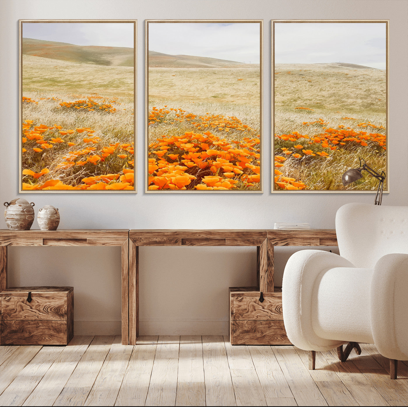 A golden field with vibrant orange poppies blooming across rolling hills under a soft, sunlit sky, creating a warm and rustic landscape.