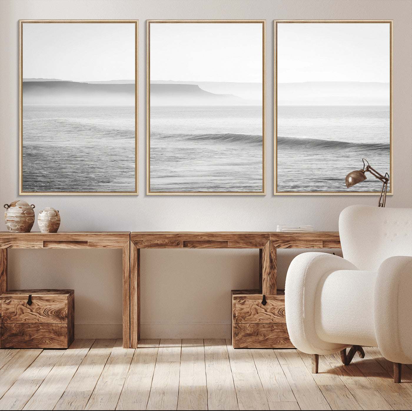 A black and white minimalist seascape featuring soft rolling waves and misty distant cliffs, creating a serene and timeless coastal atmosphere.