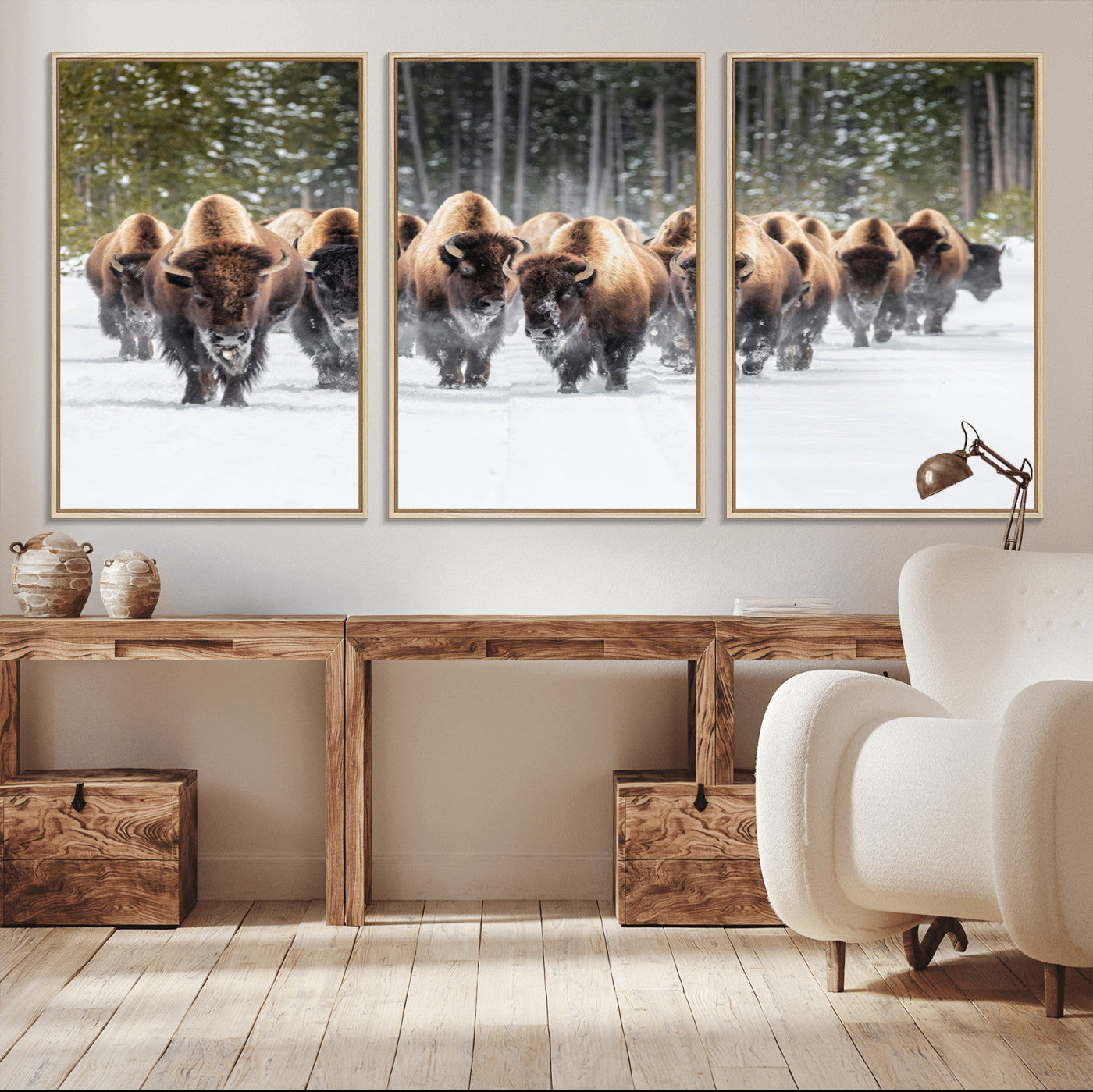 A herd of American bisons walking through a snowy forest path, perfect for rustic cabin or Western-themed wall decor.