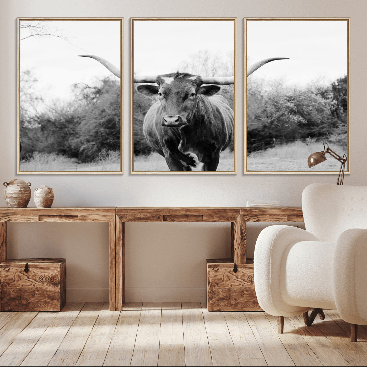 Black and white photo of a longhorn cow in a field, perfect for rustic farmhouse or western-themed interior wall decoration.