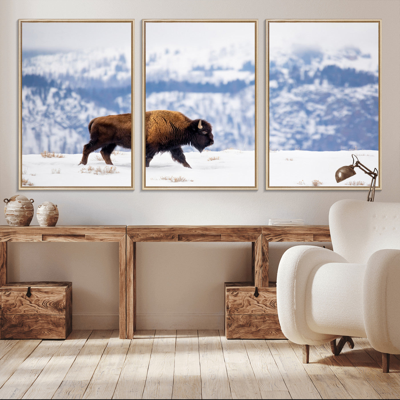 A lone bison walks across snowy ground with blue-toned mountain range behind, ideal for rustic or western farmhouse interiors.