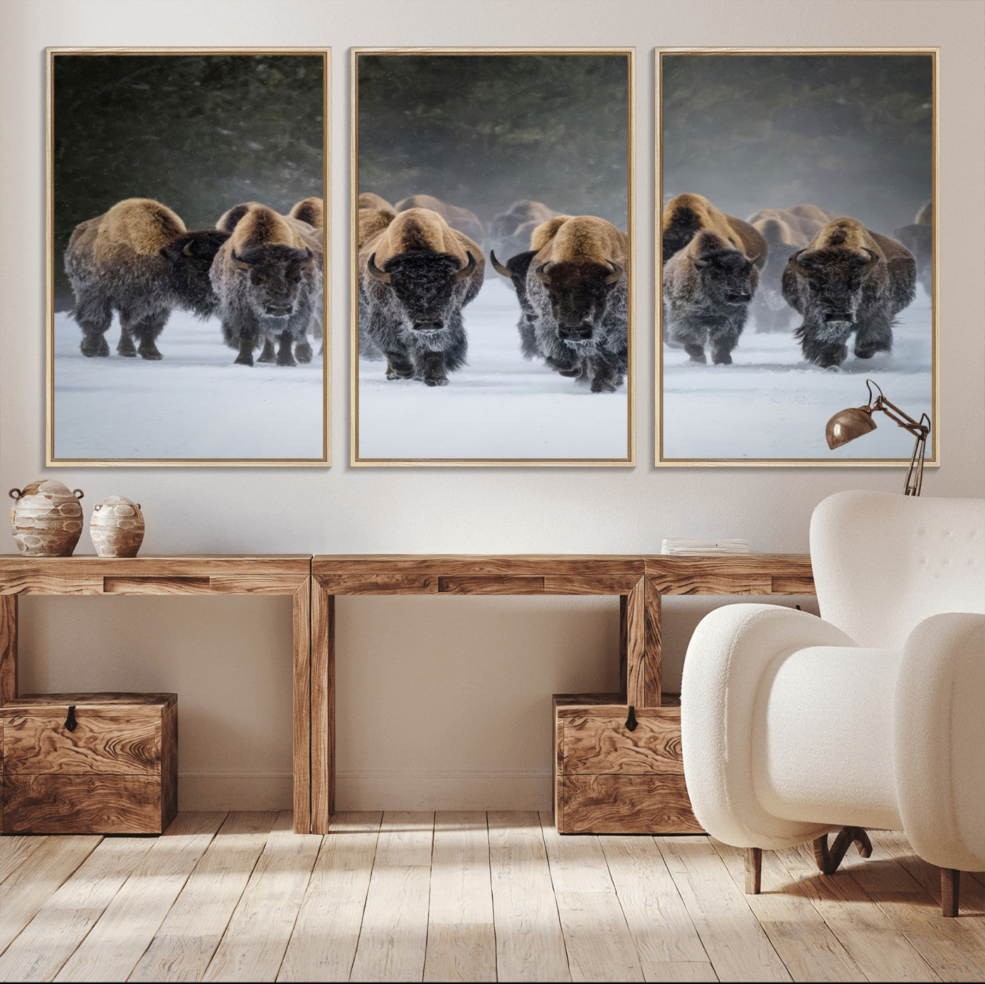 A herd of American bisons walking through deep snow in a forest, evoking a powerful rustic wilderness mood for western-style interiors.