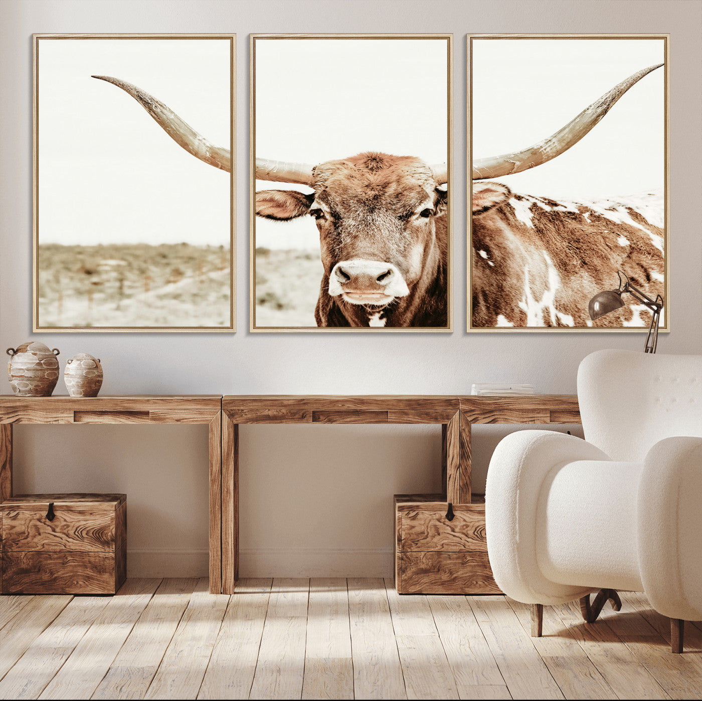 A Texas longhorn bull with wide horns, standing in a dry field under soft light, ideal for rustic farmhouse or western-themed interiors.