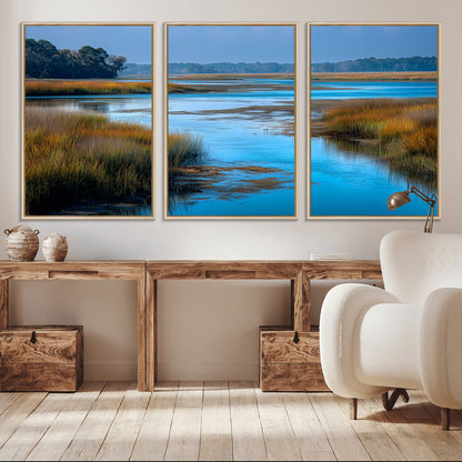 A peaceful marshland scene with calm blue water reflecting the surrounding grasses and trees, capturing the beauty of nature in a serene landscape.
