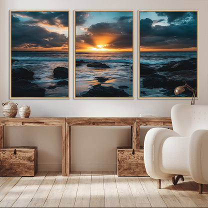 An awe-inspiring sunset over the ocean with rays of light piercing through dramatic clouds, creating a beautiful seascape with rocks in the foreground.