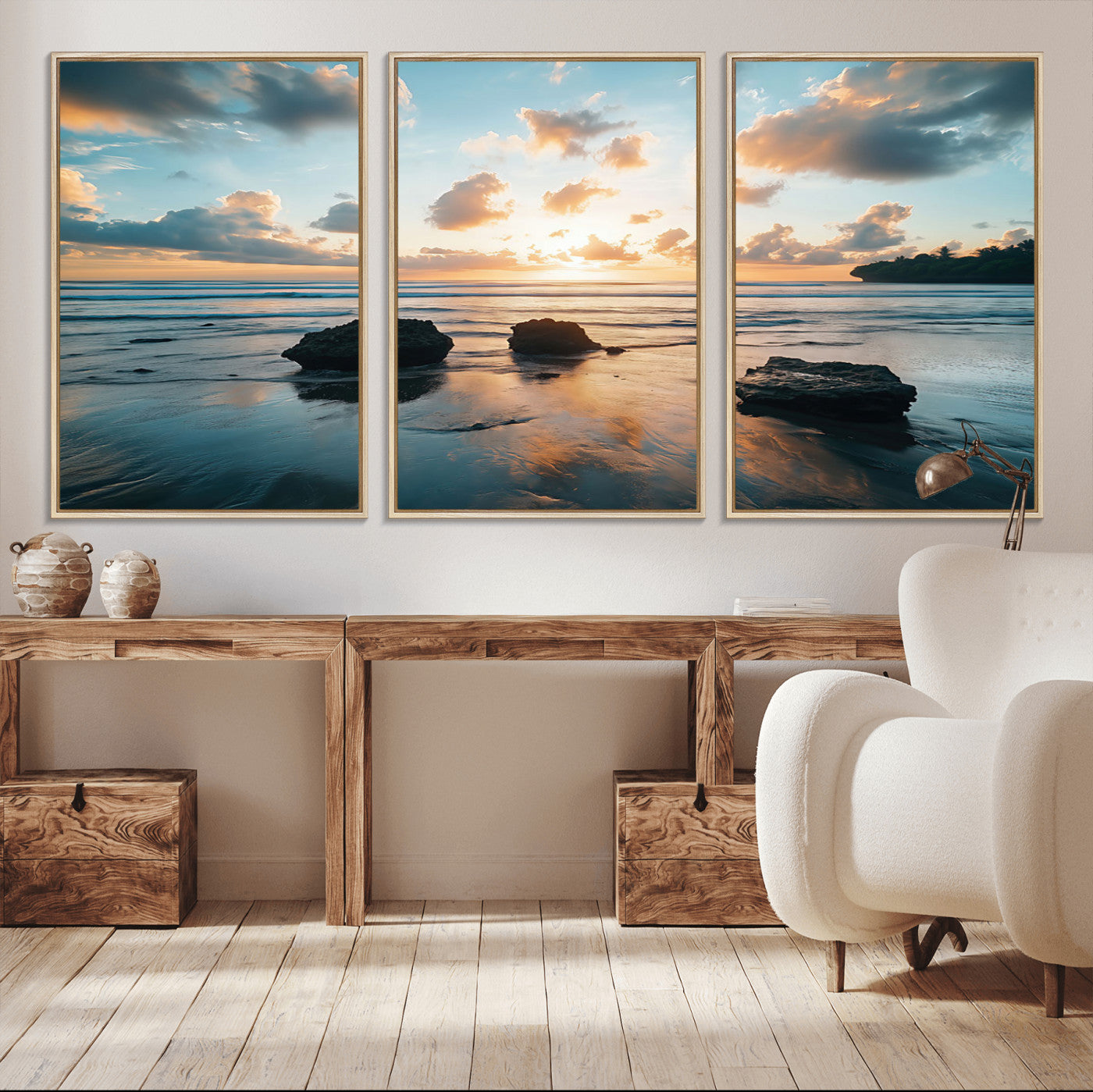 A serene beach at sunset with vibrant clouds, calm water, and rocks in the foreground reflecting the warm colors of the setting sun.
