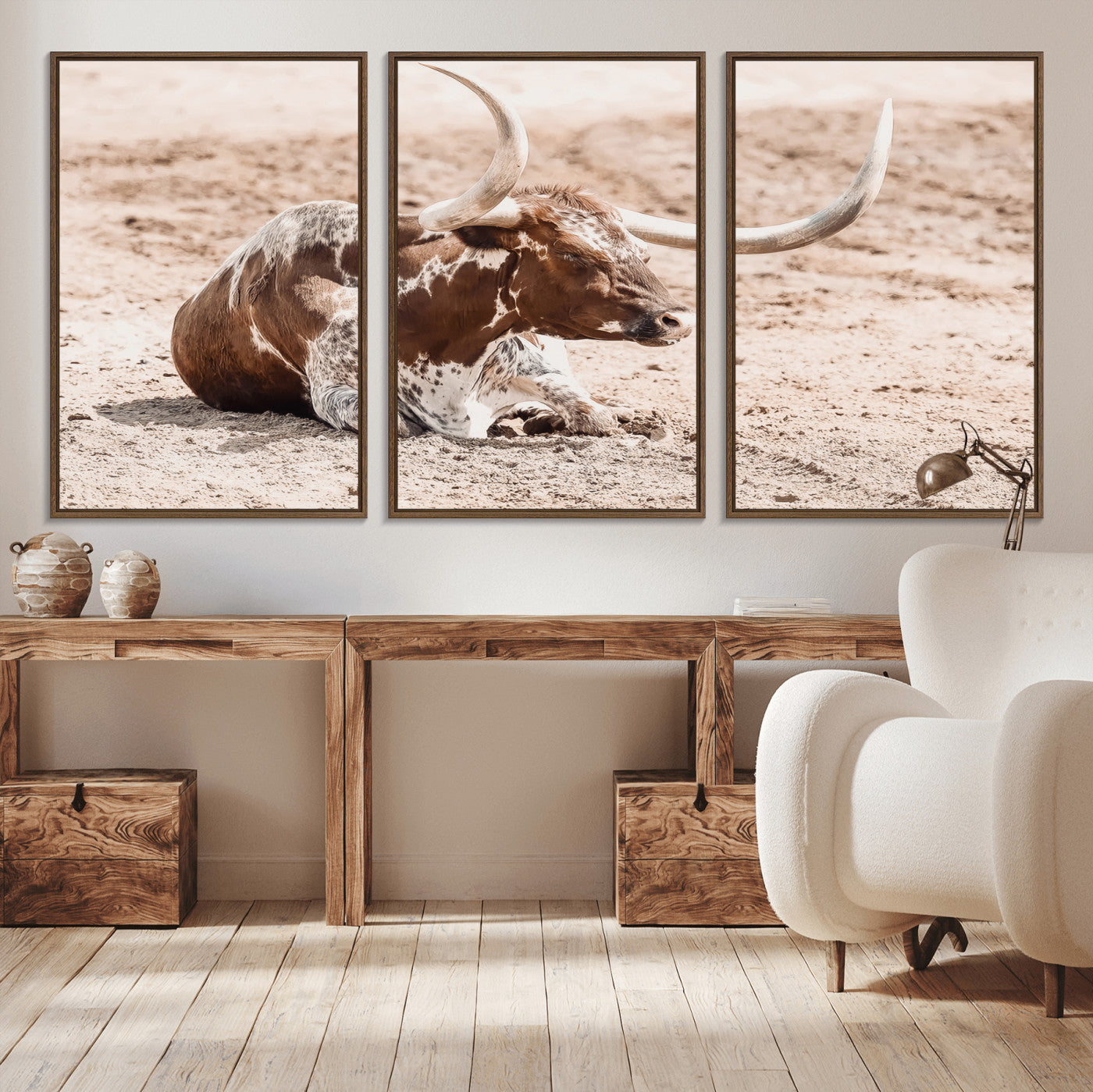 Texas Longhorn bull resting on dusty ground with warm tones, ideal for rustic western or farmhouse-themed wall decor.